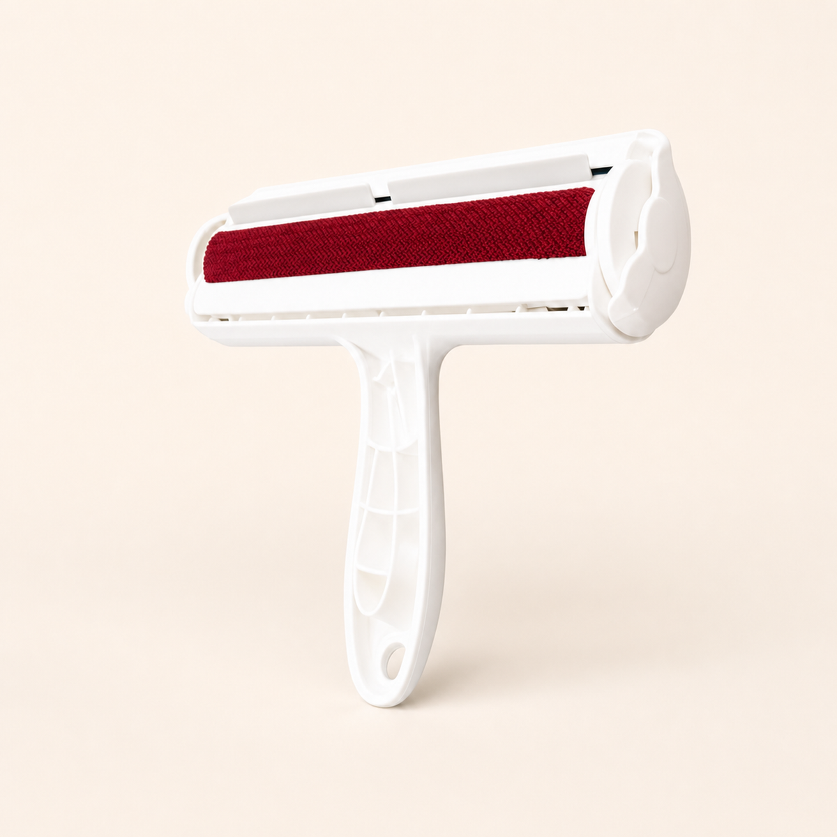Whisker & Wow pet hair remover roller in red on a cream background