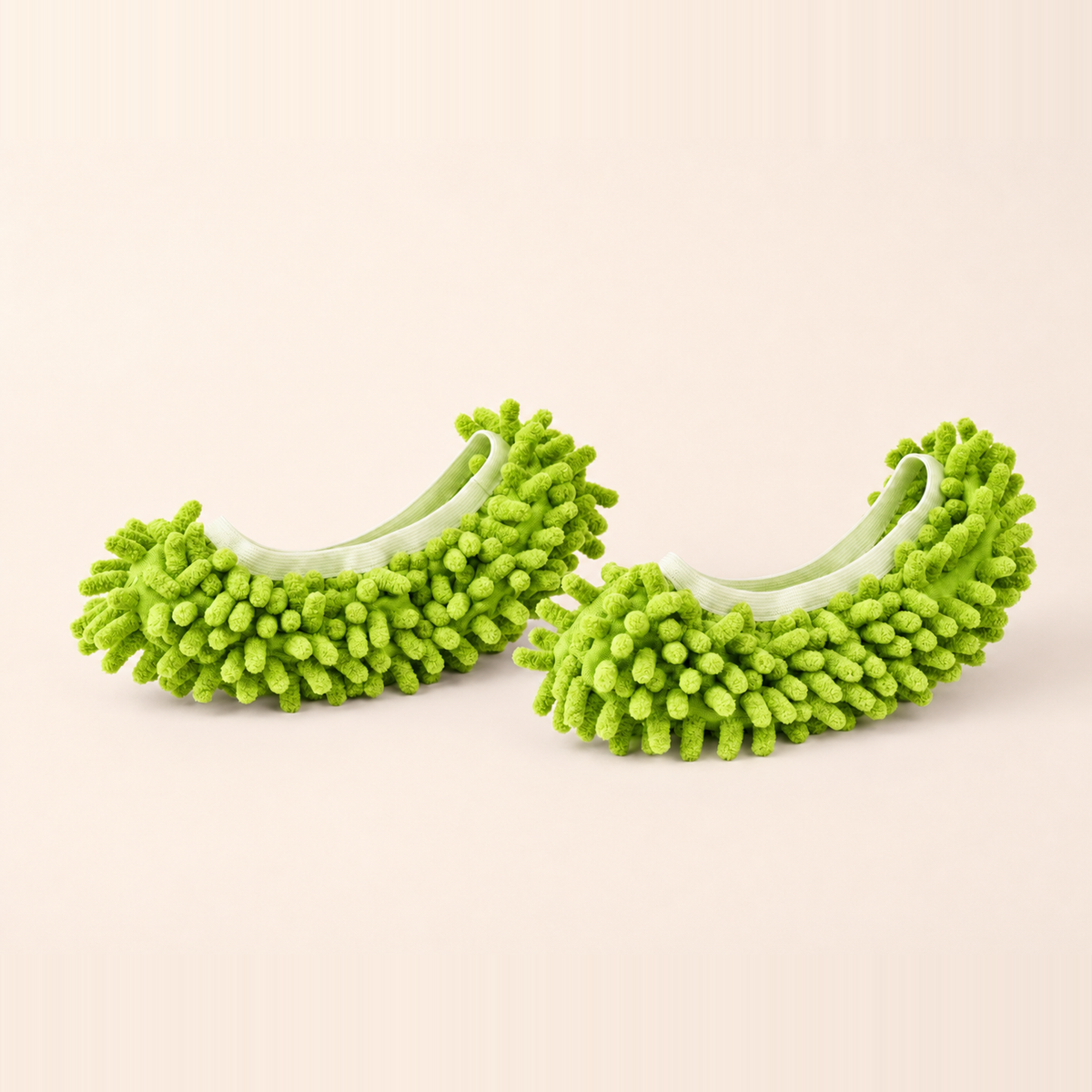 Whisker & Wow fur-catching slippers in green on a cream background